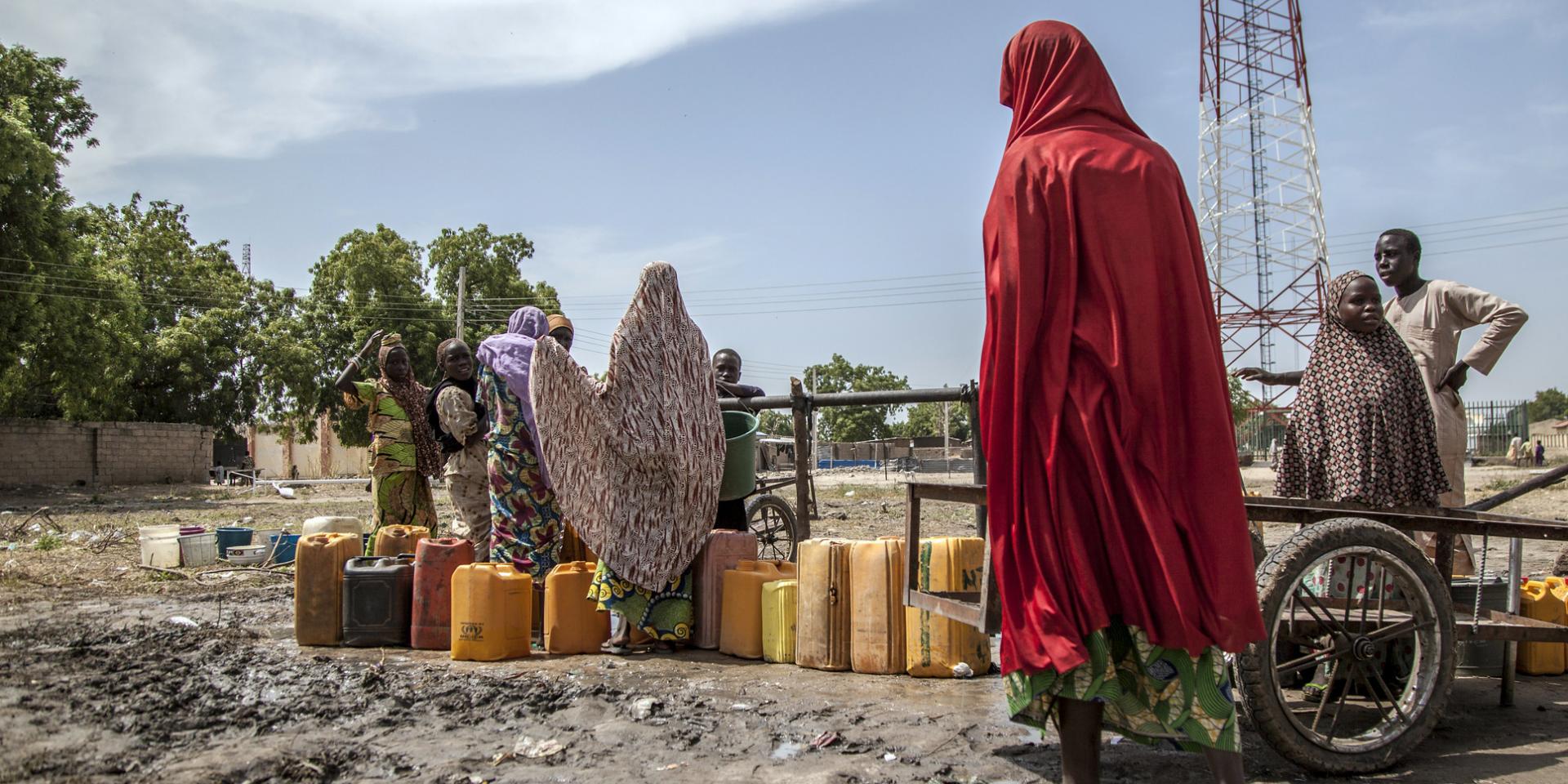 Women and children collect water from a borehole
