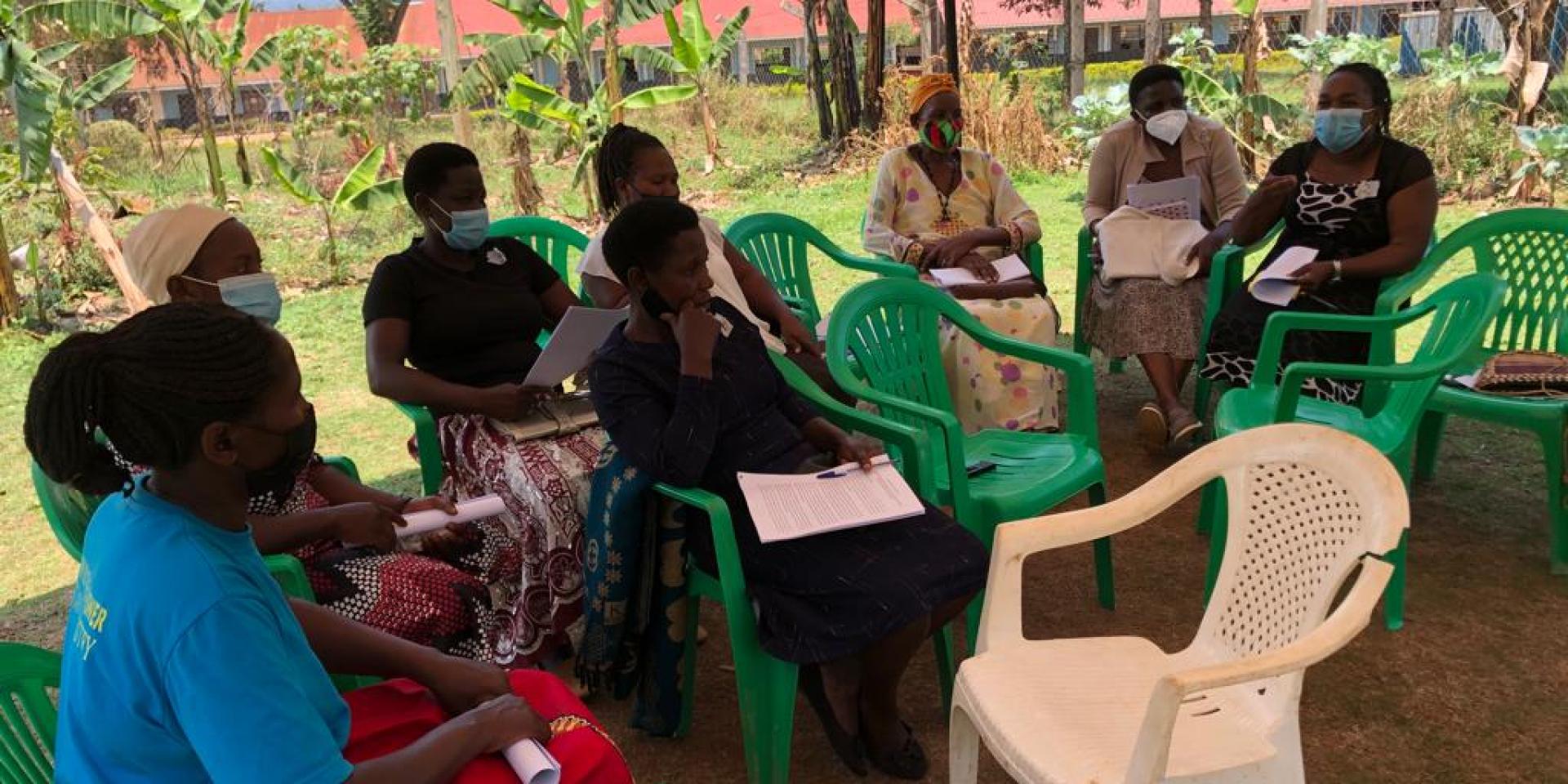Farmers sitting on chairs during survey.