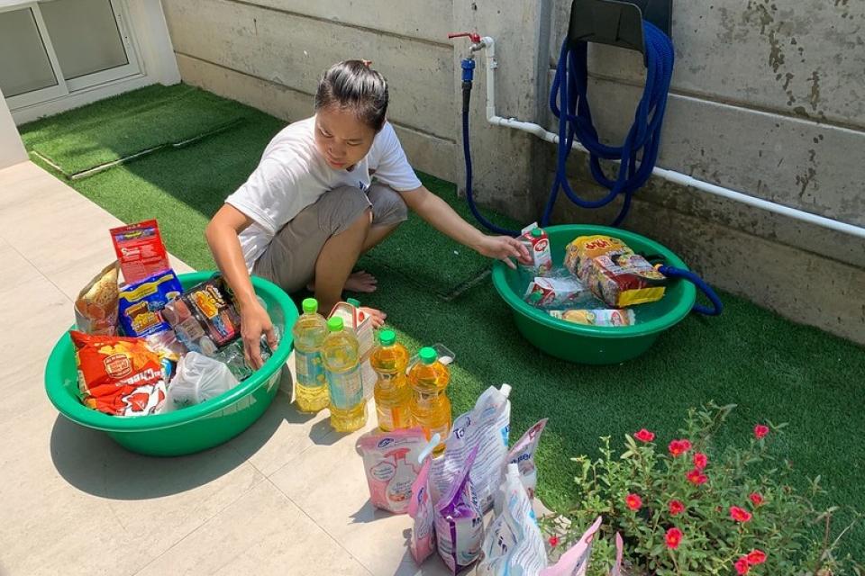 Cleaning your groceries is a new normal during COVID-19. © ILO/Piemsuk Wanichupatumkul.